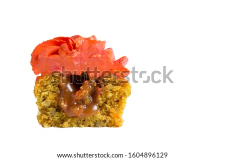 Half a cupcake with red cream, inside with caramel.