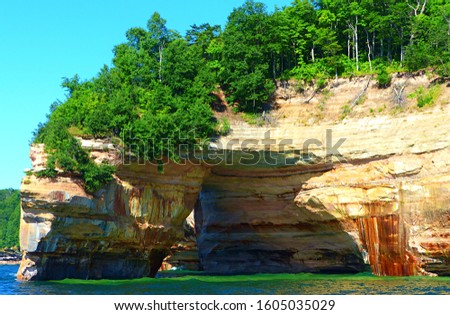 A rock arch known as "Lover's Leap" shines in summer's afternoon light along the coast of Lake Superior at Pictured Rocks National Lakeshore in Michigan's Upper Peninsula. 