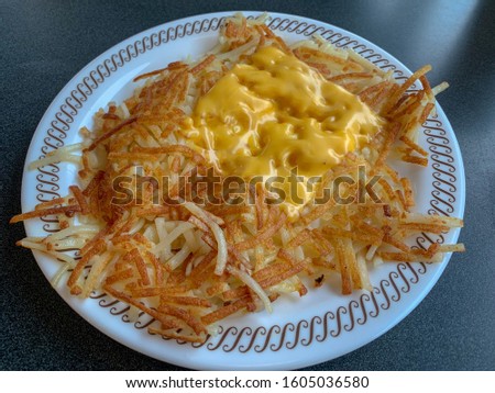Hash brown potatoes with melted cheese.
