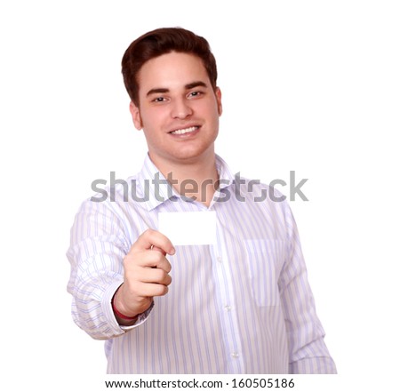 Portrait of a charismatic redhead man on stylish shirt holding up a business card while smiling and looking at you on isolated background - copyspace