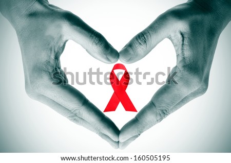 man hands forming a heart with his hands and a red ribbon for the fight against AIDS on a white background Royalty-Free Stock Photo #160505195
