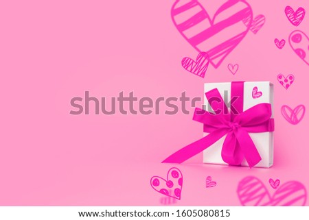 Valentine's Day background. Valentines day concept. Happy Womens day template design. Decorative white gift box with red bow on pastel pink background. Copy space
