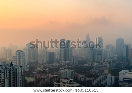 PM 2.5 dust in Bangkok or the center city,Capital city are covered by heavy smog,Misty morning and sunrise in downtown with bad air pollution, the Place to risk of cancer,Thailand-Image Royalty-Free Stock Photo #1605118513