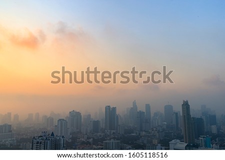 PM 2.5 dust in Bangkok or the center city,Capital city are covered by heavy smog,Misty morning and sunrise in downtown with bad air pollution, the Place to risk of cancer,Thailand-Image Royalty-Free Stock Photo #1605118516