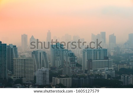 PM 2.5 dust in Bangkok or the city center,Capital city are covered by heavy smog,Misty morning and sunrise in downtown with bad air pollution, the Place to risk of cancer,Thailand-Image Royalty-Free Stock Photo #1605127579