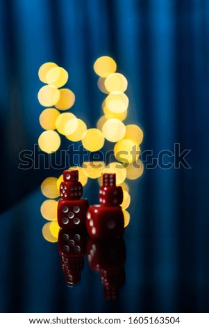 Red dices on a reflected surface with  nice blurry bokeh effect photography art
