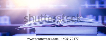 The blurred book that is bewitched with magic, the magic light in the dark, with the bright light shining down as the power to search for knowledge. For research and use as a blurred background