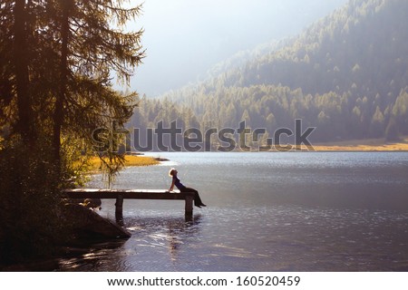 young woman enjoy the nature on the mountain lake Royalty-Free Stock Photo #160520459
