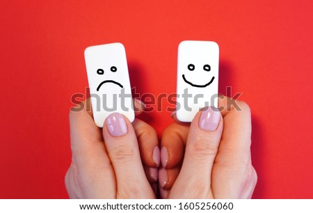 Good mood and bad mood concept with blocks and smiles in a hands  Royalty-Free Stock Photo #1605256060
