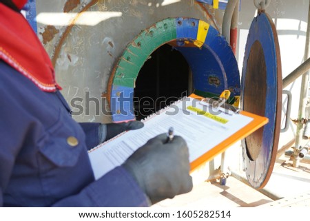 (Focus on Main hole) Construction supervisor use checking to inspect before entering work in confined spaces high risk work construction site.