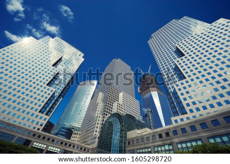 Classic city skyline of shiny glass office tower skyscrapers with blue sky