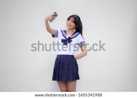 japanese teen beautiful girl in student uniform using her smart phone Selfie