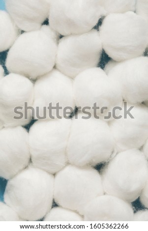 Soft cotton balls close up, round cotton swabs for facial cleansing, flat lay. Hygiene and skincare beauty product