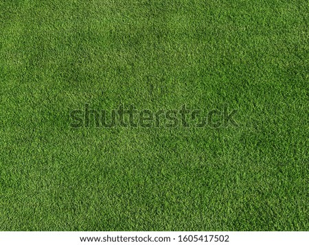 Artificial grass background with copy space.wallpaper for text and picture.green texture.artificial turf.The surface is made of synthetic fibers.Made from Polyethylene or polypropylene