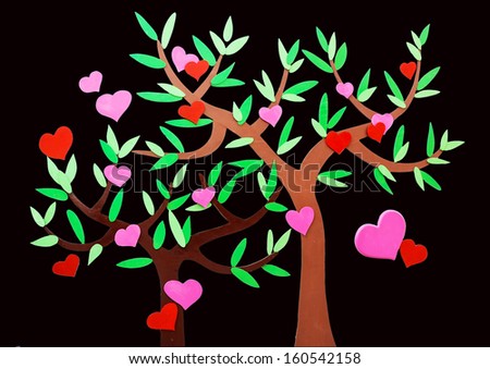 Heart-shaped symbol and tree on the black background
