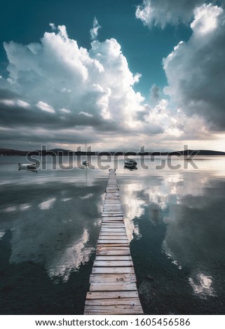 Clouds boats pier reflection graphic
