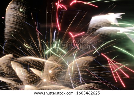 neon lighting from an aged photo of fireworks. abstract painting with bright multi-colored beams of lightning on a black background