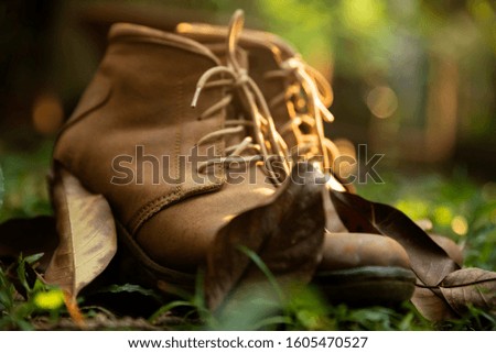 A pair of brown boot on grass