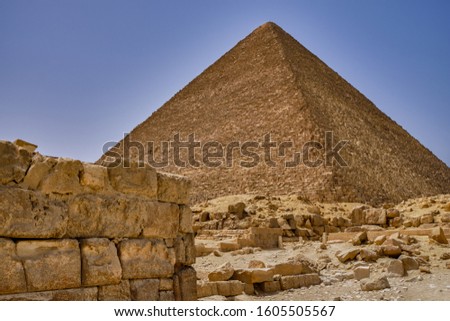 The Great Pyramid of Giza (Pyramid of Khufu or Pyramid of Cheops) is the oldest and largest of the three pyramids in the Giza pyramid complex, the oldest of the Seven Wonders of the Ancient World Royalty-Free Stock Photo #1605505567
