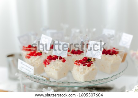 Mousse of white chocolate with coconut decorated by berries, Picture for a menu or confectionery catalog
