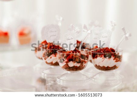 Red velvet cake, pastry mixed with milk cream, decorated by berries. Picture for a menu or confectionery catalog