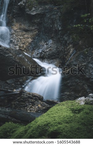 winding waterfall with green moss