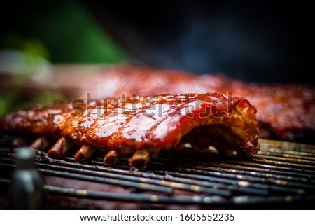 Smoked BBQ Ribs on Grill Egg Smoker Close Up Royalty-Free Stock Photo #1605552235