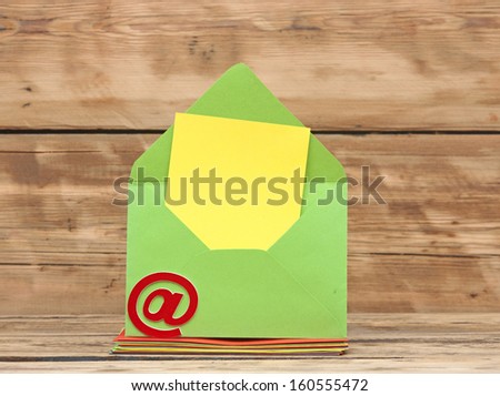 E-mail symbol and colorful envelopes on old wooden background. concept of E-Mail 