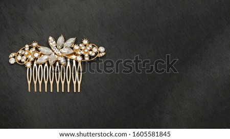 bridal hair comb luxury jewel, isolated on stone background, space for text on the right side, stock photography