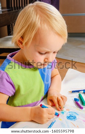 child girl painted with colored crayons