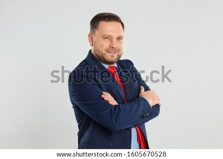 Portrait of happy mature man on light grey background