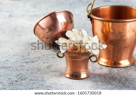 Set of 3 copper miniatures on concrete background. Copy space for text, food photography props