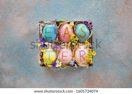 Easter background card with decor eggs in a box and flowers