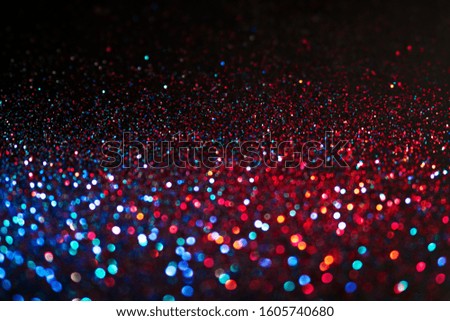 Multicolored shining glitter in focus and out of focus, abstract shiny background. Multicolored glitter magic background.