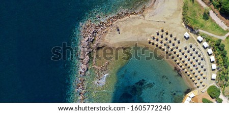 Aerial drone ultra wide top down photo of beautiful organised sandy beach near cape Sounio, Attica, Greece