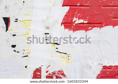 Poster plastered torn street art style placard paper texture on exposed bricks