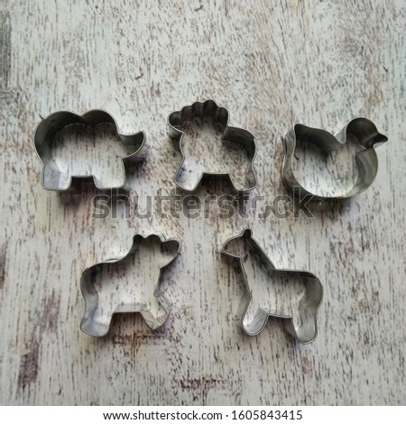 set of animal cookie cutters to make decorated cookies on abstract background, made from stainless steel