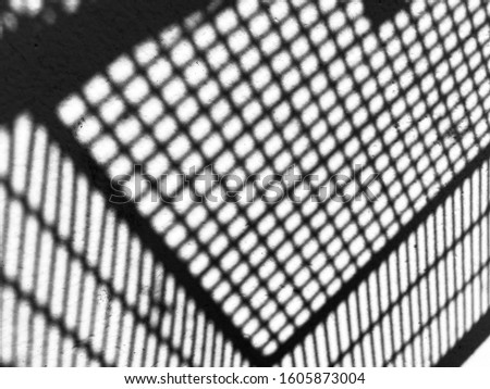 Grid Shadow on a white wall. Black and white color