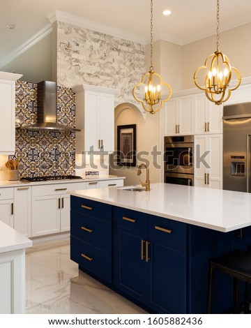Beautiful luxury home kitchen with white cabinets. Royalty-Free Stock Photo #1605882436