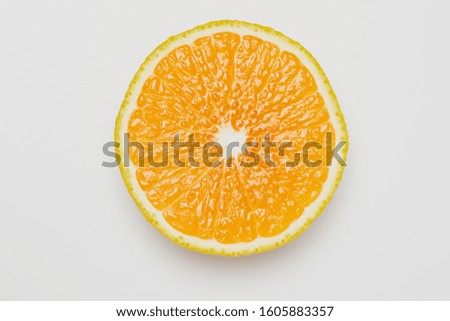 cut orange on white background. Royalty-Free Stock Photo #1605883357