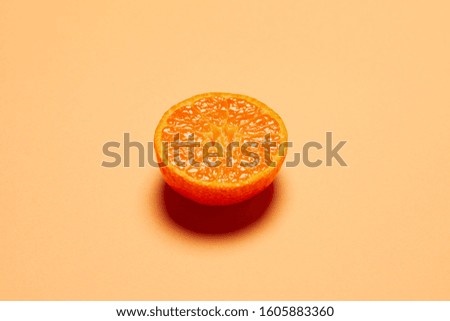 half fresh oranges on orange background. Royalty-Free Stock Photo #1605883360