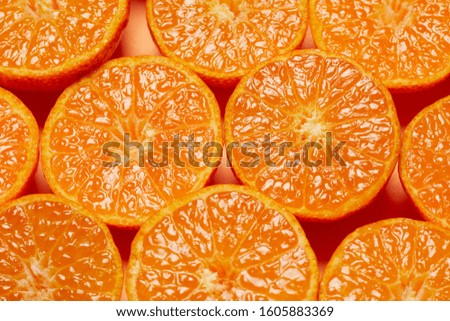 Slices of fresh oranges as a background, top view.  Royalty-Free Stock Photo #1605883369