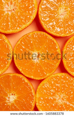 Slices of fresh oranges as a background, top view.  Royalty-Free Stock Photo #1605883378