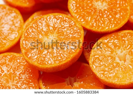 Slices of fresh oranges as a background, top view.  Royalty-Free Stock Photo #1605883384