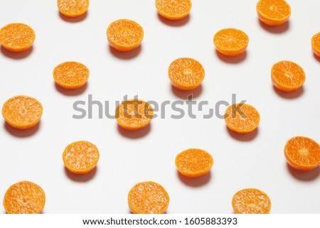 many half fresh orange on white background. Royalty-Free Stock Photo #1605883393