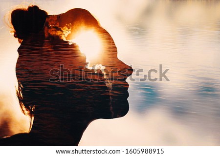 Sun peeks out from behind the clouds in woman's head. Royalty-Free Stock Photo #1605988915