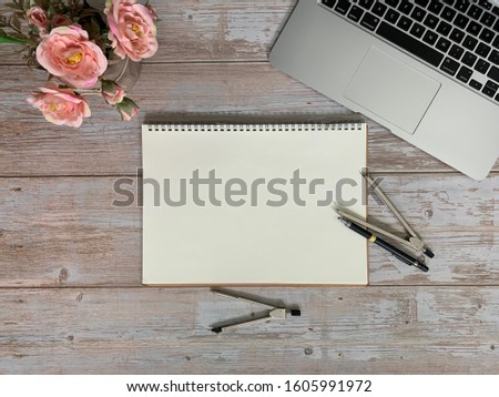 Image of laptop, light orange roses, protractor, mechanical pencil, drawing note pad, on wooden table background. Concept of business, architect copy 