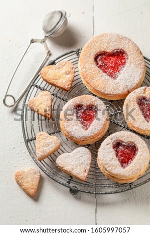 Cute valentine cookies with red strawberries jam