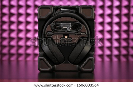 Professional Modern headphones with a microphone for gamers on a pink background