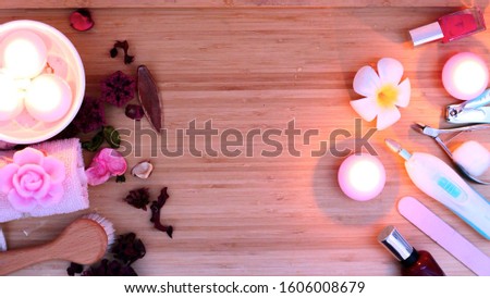 Image of a set of nail tools for manicure and pedicure on a  wooden background. Gel polishes, nail files top view.